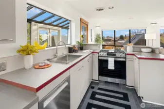 Bright U-shaped kitchen connects sunroom to greatroom