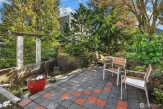 Private garden patio framed by mature landscaping—ideal for dining or quiet mornings