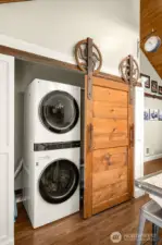 Laundry room w/storage area & tankless water heater