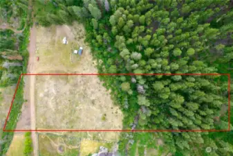 The property has been surveyed and corners are marked.  The red outline delineates the approximate location of the parcel boundaries.