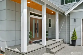 Custom details are evident as you walk up to the porch.  Notice the gorgeous front french style front doors, covered with inset lighting porch and the complimenting siding styles.