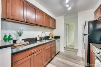 Kitchen features gorgeous cherry cabinets and granite countertops.