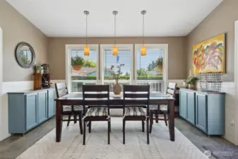 Dining room features shiplap accent wall and slate tile.