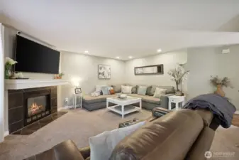 Another view of living room. To the right is the main entrance, hallway to 1/2 bath, Laundry room and Stairway to upstairs bedrooms.