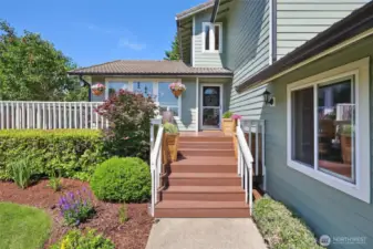 Step up to your front porch and wrap-around deck. Find views of the mountain here on a clear day.