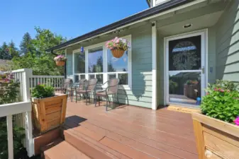 Deck wraps around to another side door off the kitchen.