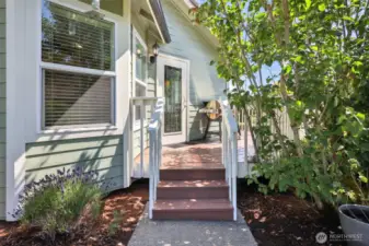 Side door that exits the dining/kitchen area. An excellent way to entertain. Show here is space for your BBQ/Pellet grill. Stairs lead to the side yard.