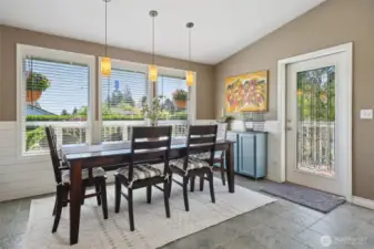 Open concept dining space with fun pendent lights. Catch views of the mountain here as well. Full light Codel door was added years ago and adds additional light to the already bright space.