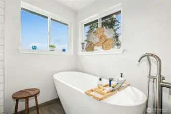 Soaker tub in the 5 piece bathroom. Views out the bathroom windows--peek-a-boo view of the Olympic Mtns.