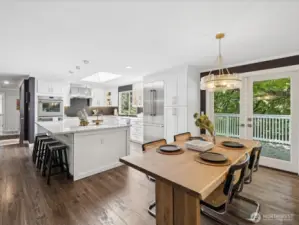 From near living room / fireplace looking across the home towards kitchen, open floorplan lives large & lends itself to amazing entertainment opportunities full of natural light