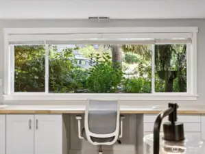 View out windows to front entrance / mature landscaping & offering privacy and filtered natural light