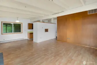 Another view of the living room, showing the wood accent wall adjacent to the front door.