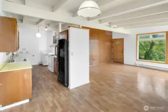 From the dining area, this is the view back to the front entry, including the upstairs kitchen and laundry area.
