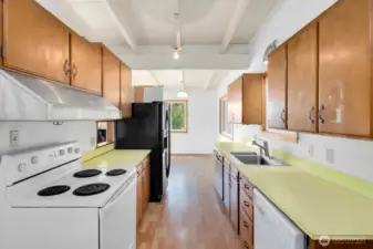 View of the kitchen with the dining area in the background.