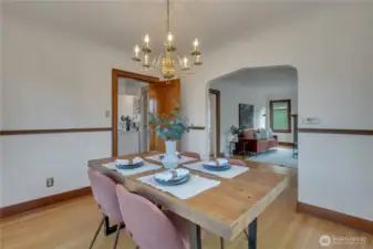So many beautiful touches with the coved transition to the living room, swinging mahogany door to he kitchena nd a mahogany chair rail