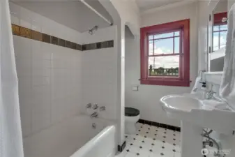 Update main floor full bathroom with tile shower surround and beautiful pedestal sink!