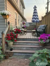 A view of this deck with beautiful planted pots & furniture!