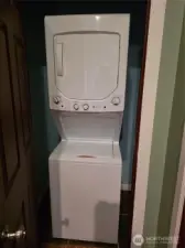 Stacked unit laundry space in closet in hallway