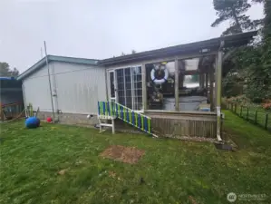 Sunroom on the side of the house with the hot tub.