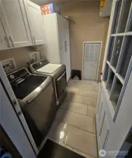 Laundry room with plenty of storage cabinets.