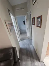 Hallway to the guest bathroom and two bedrooms.