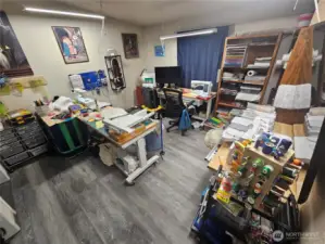 Primary bedroom with lots of space is currently being used for a sewing room.