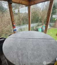 Wall of windows in the sunroom and the hot tub.