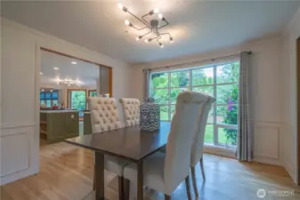 Spacious dining room with French doors to the pathway to the pergola and firepit.