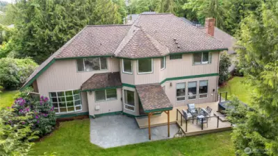 View of the back of the home. Plenty of room to entertain with the beautiful deck, hot tub, covered BBQ space and patio!