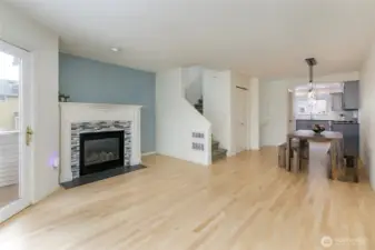Looking back toward the kitchen & dining, plus  rich warm maple flooring