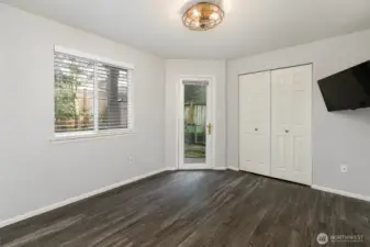 another large bedroom on main level, its by desing a unique split type entry space for 2nd bedroom. It is located off the back private yard with lux flooring