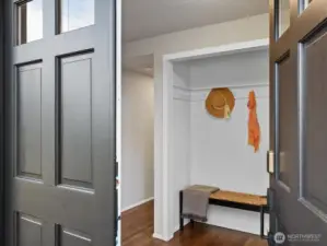 Inviting entry with nook for organizing coats and shoes.