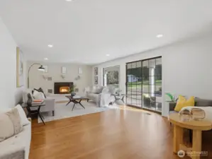 Cozy up by the fireplace in your second family/living room with direct access to the backyard/patio and garage.