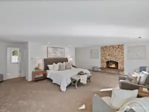 Expansive primary suite with cozy fireplace and generous layout, offering space for both rest and relaxation.