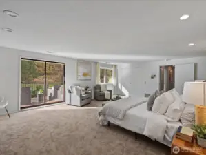 Primary suite with direct outdoor access and large windows, bringing in natural light and backyard views.