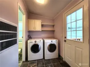 Laundry room with added storage. The furnace and hot water heater is also in the laundry room