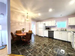 Wide angle view of the eat in kitchen with space for a large dining table