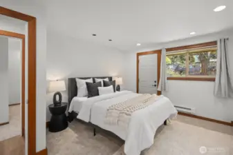 The spacious primary suite easily accommodates furniture of any size and features a large walk-in closet, brand new carpet and fresh paint—plus a private front deck to enjoy your own peaceful retreat.