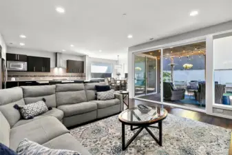 Double sliding glass doors open to create a huge indoor / outoor space.