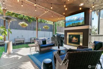 Serene outdoor deck area with gas fireplace and TV.