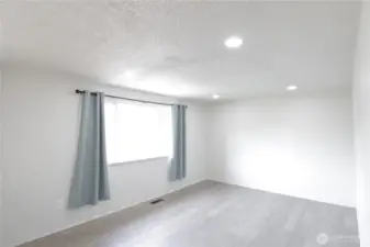 Spacious living room with recessed lighting.