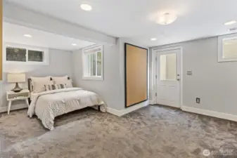 One of two lower-level bedrooms featuring great ceiling height, abundant natural light, and a separate entrance—ideal for guests, office, or multi-generational living.