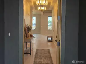 Grand entry with beams and double chandeliers