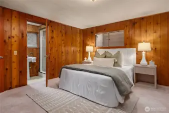 Lower level bedroom with an en-suite 3/4 bathroom. Love those knotty pine paneled walls!