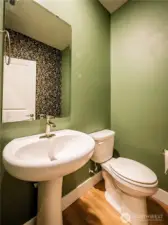 LOVELY HALF BATH ON THE MAIN...COOL WALLPAPER ON OPPOSIT WALL..