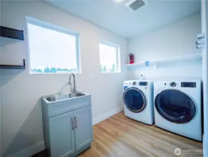 BIG LAUNDRY ROOM ON SECOND FLOOR WITH SHELVING AND UTILITY SINK