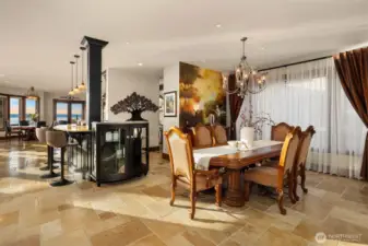 The formal dining room exudes warmth and old-world elegance with a breathtaking hand painted Tuscan mural that transforms the space into an Italian countryside retreat.