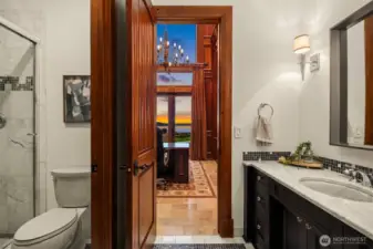 Convenient three-quarter bath off the library with marble countertops, shower and flooring completely complementing the rich Sapele woodwork.