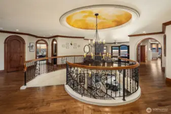 Astounding upper level continues with arched architectural entryways, extensive millwork, wood handrail wraps and a most eye stunning hand painted ceiling dome.
