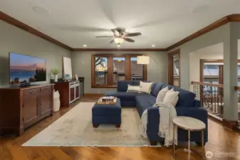 A wonderful entertainment room is ready for game day or movie night complete with contemporary cabinetry, custom stainless steel countertop and sink and an under counter refrigerator.